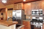 Cloud 9 Cabin kitchen with stainless steel appliances. 